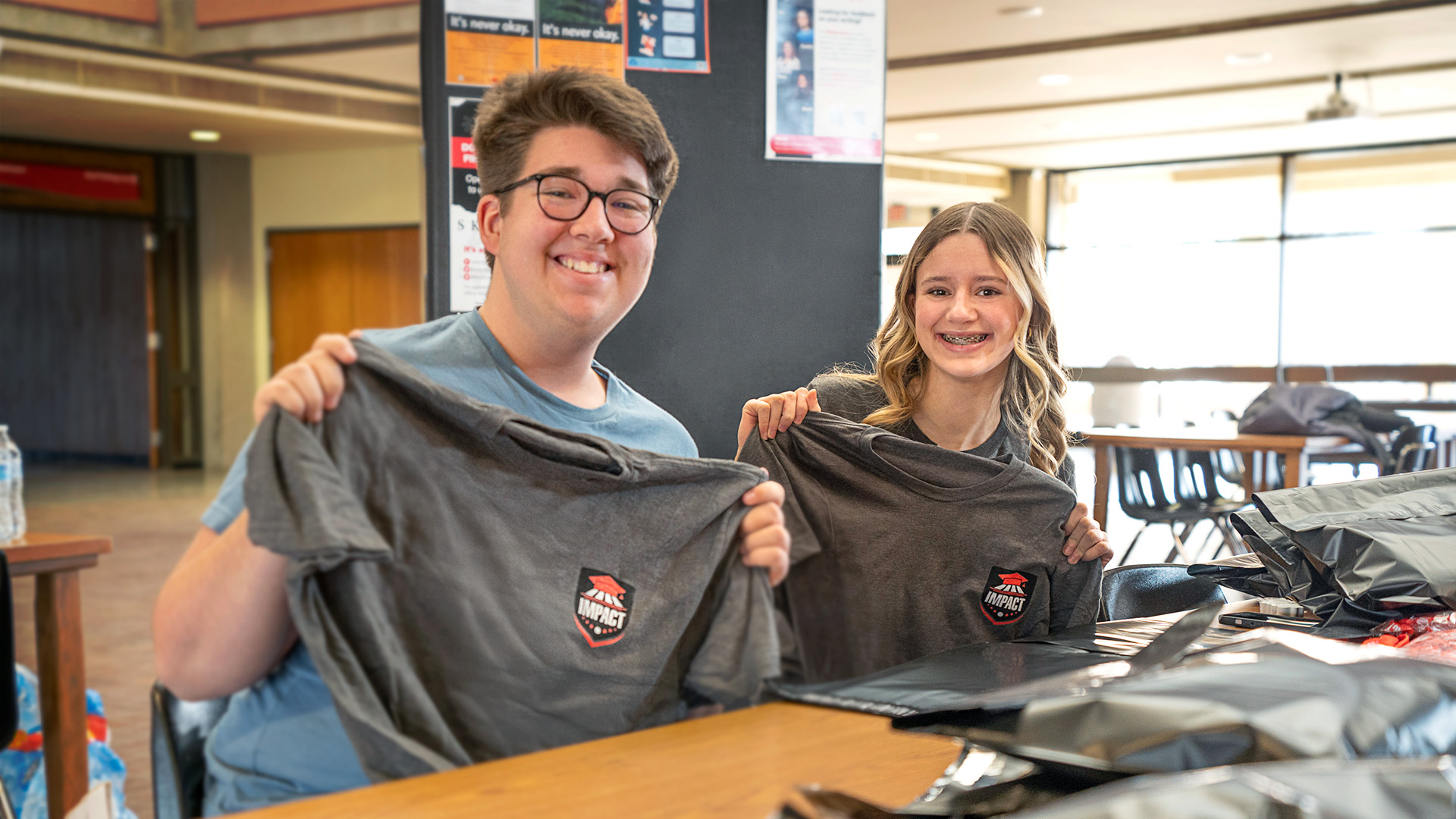 2025 Impact Students posing with their new Impact shirt