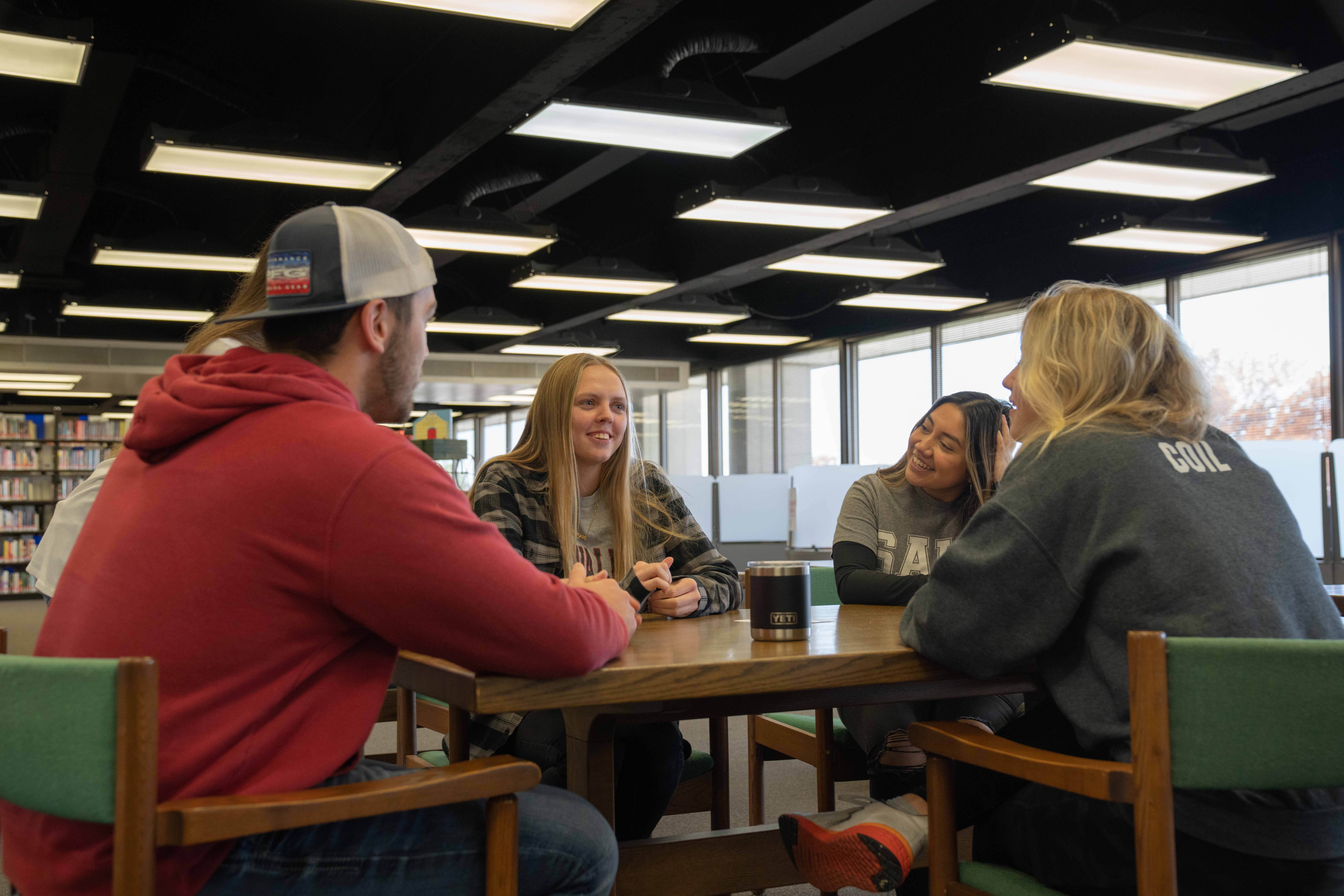 Students talking around a table