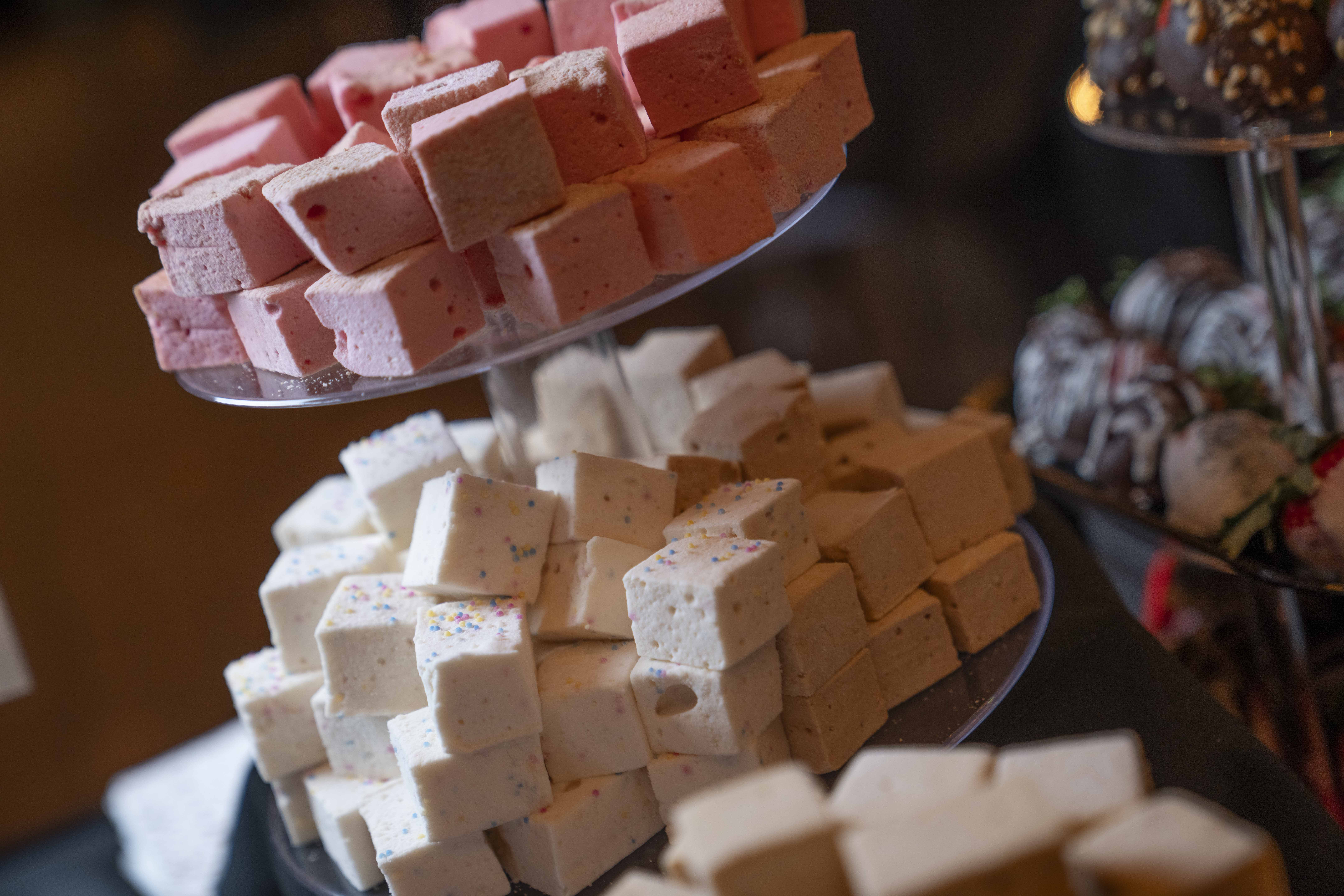 Close-up of a two-tiered rack of gourmet marshmallows.