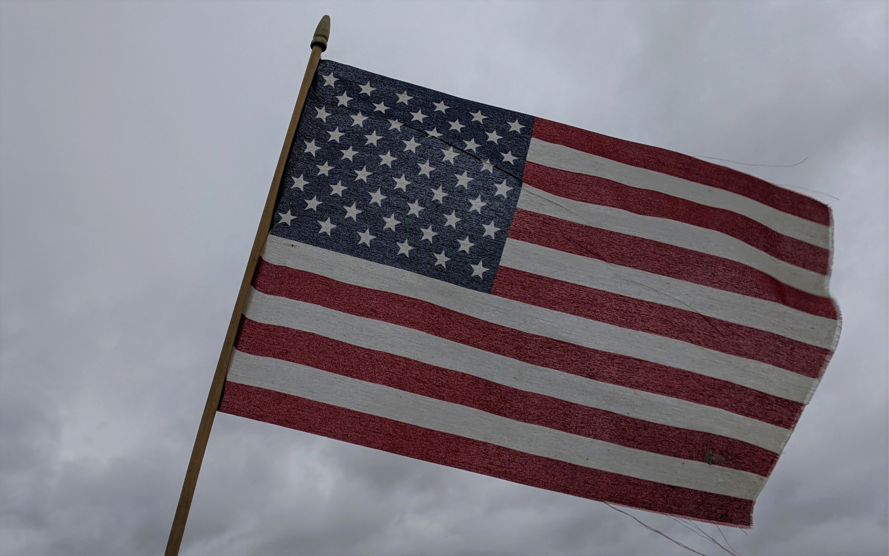 A United States flag weathers the storm