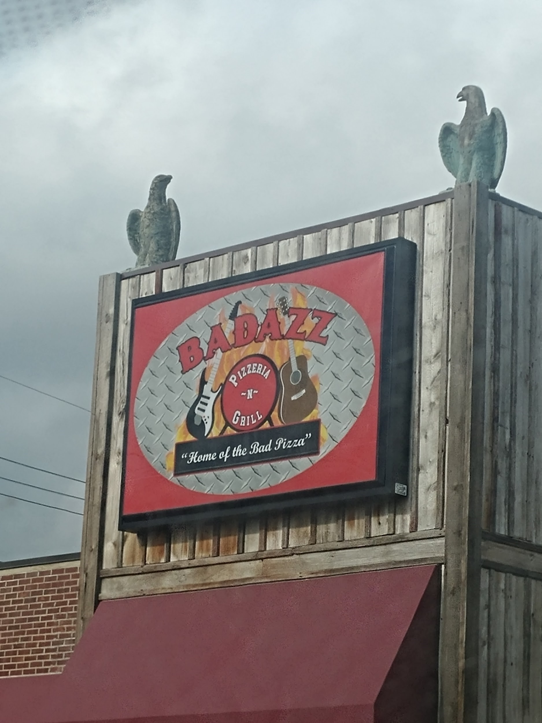 The restaurant's sign on the front wall of the building