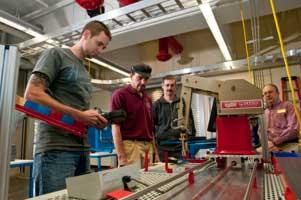 Students with instructor in electronics lab.