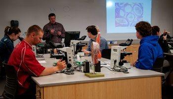 Science instructor with students in lab